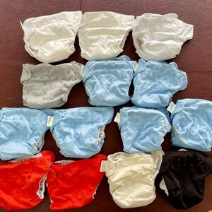 21 mostly NEVER USED 14 Bum Genius (+11 inserts) & 7 Elemental Joy Diapers